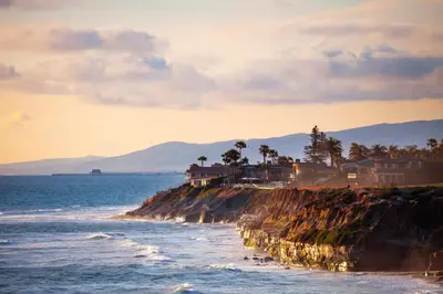 a rocky shoreline with houses and the ocean at 329 Oak Ave in Carlsbad