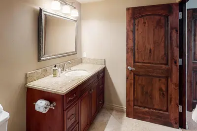 a bathroom with a sink and a mirror and a door at 329 Oak Ave in Carlsbad