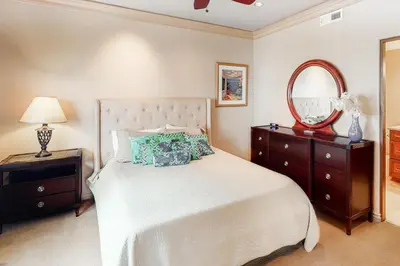 a bedroom with a bed with a mirror and a dresser at 329 Oak Ave in Carlsbad