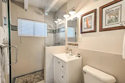 a bathroom with a toilet and a sink and a shower at San Diego Hub with Bay Views - 1 Block to Beach! in San Diego
