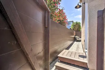 a wooden wall with a bench on a sidewalk at Dog-Friendly San Diego Home - 1 Mi to Ocean Beach in San Diego