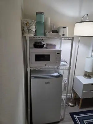 a microwave oven sitting on top of a refrigerator at Resort Like Stay at a Cozy Relaxing Private Room Near UCI in Irvine