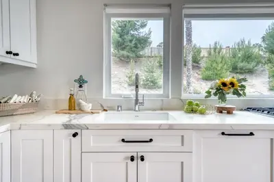 a white kitchen with a sink and a window at 727 Sonrisa St home in Solana Beach