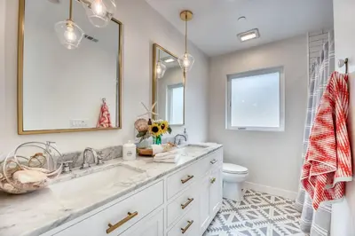 a white bathroom with a sink and a toilet at 727 Sonrisa St home in Solana Beach