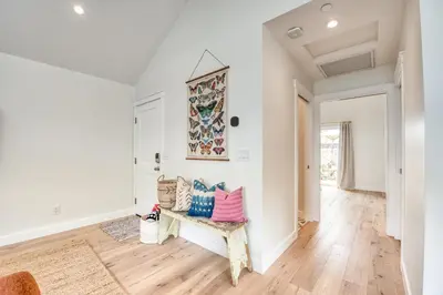 a living room with a couch and wooden floors at 727 Sonrisa St home in Solana Beach