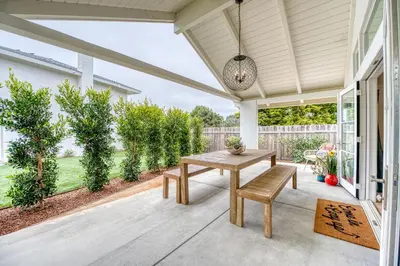 a patio with a table and chairs on a porch at 727 Sonrisa St home in Solana Beach