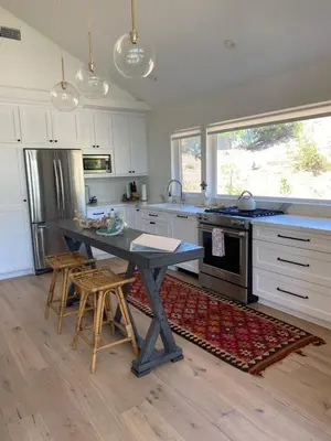 a kitchen with a table and some chairs in it at 727 Sonrisa St home in Solana Beach