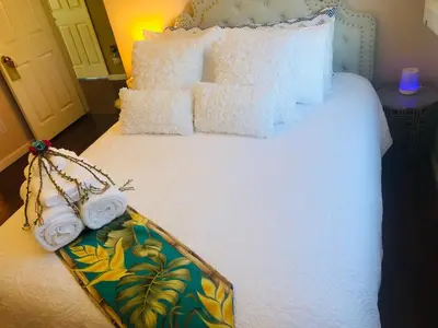 a bed with white pillows and towels on it at Balloons and Wine in Murrieta