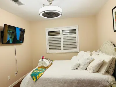 a bedroom with a bed with white pillows at Balloons and Wine in Murrieta