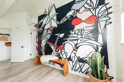 a large painting on the wall in a living room at The Green Room Hotel in Oceanside