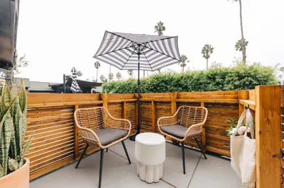two chairs and an umbrella on a patio at The Green Room Hotel in Oceanside