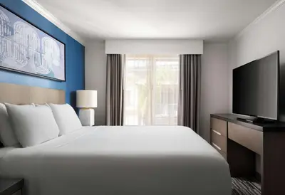 a hotel room with a large bed and a television at Hyatt House San Diego Sorrento Mesa in Sorrento