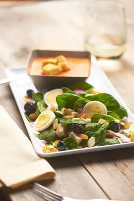 a plate of food with a salad on a table at Hyatt House San Diego Sorrento Mesa in Sorrento