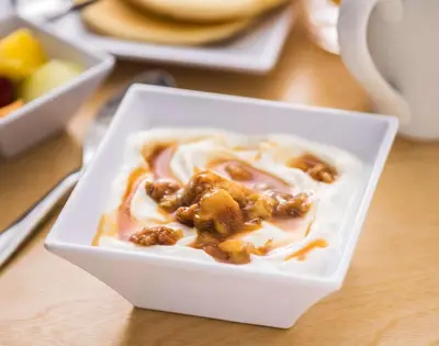 a white bowl of food with nuts on a table at Hyatt House San Diego Sorrento Mesa in Sorrento