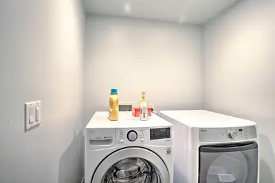 a white laundry room with a washer and dryer at Chic San Diego Abode Rooftop Balcony and Bay Views! in San Diego