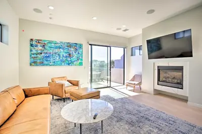 a living room with a couch and a fireplace at Chic San Diego Abode Rooftop Balcony and Bay Views! in San Diego