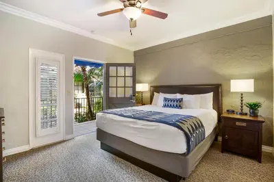 a bedroom with a bed and a ceiling fan at El Cordova in San Diego