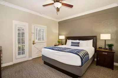 a bedroom with a bed and a ceiling fan at El Cordova in San Diego