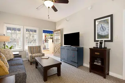 a living room with a couch and a tv at El Cordova in San Diego