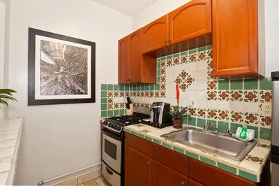 a kitchen with a sink and a stove at El Cordova in San Diego