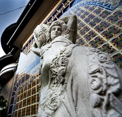 a statue of an angel standing in front of a building at El Cordova in San Diego