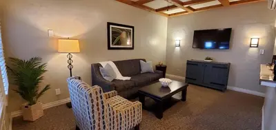 a living room with a couch and a tv at El Cordova in San Diego