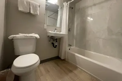 a bathroom with a toilet and a sink and a tub at Big 7 Motel Chula Vista I-5 in Chula Vista