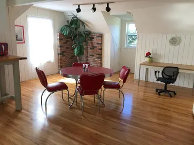 a dining room with a table and red chairs at Secluded, Charming and Unique! Spacious Apartment EXCELLENT Central Location in San Diego