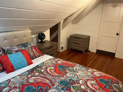 a bedroom with a bed with a bedspread and a table at Secluded, Charming and Unique! Spacious Apartment EXCELLENT Central Location in San Diego