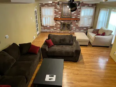 a living room with couches and a brick wall at Secluded, Charming and Unique! Spacious Apartment EXCELLENT Central Location in San Diego