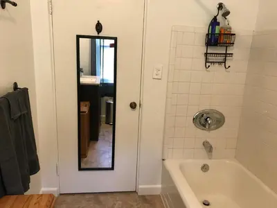 a bathroom with a bath tub and a mirror at Secluded, Charming and Unique! Spacious Apartment EXCELLENT Central Location in San Diego