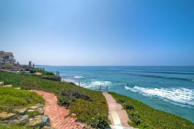 a path leading down to the ocean on a beach at Oceanfront Villa with Private Beach Access, Remodeled Kitchen in Carlsbad