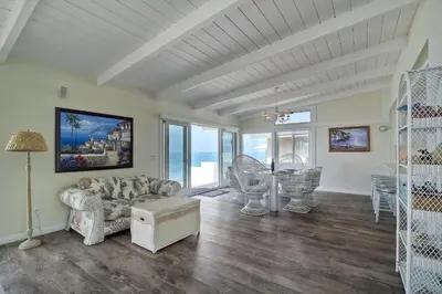 a living room with a couch and a table at Oceanfront Villa with Private Beach Access, Remodeled Kitchen in Carlsbad