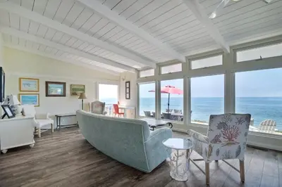 a living room with a large tub and the ocean at Oceanfront Villa with Private Beach Access, Remodeled Kitchen in Carlsbad