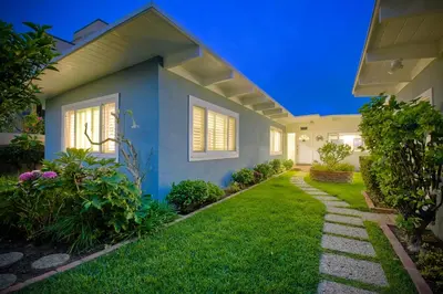 a house with a green lawn in front of it at Oceanfront Villa with Private Beach Access, Remodeled Kitchen in Carlsbad