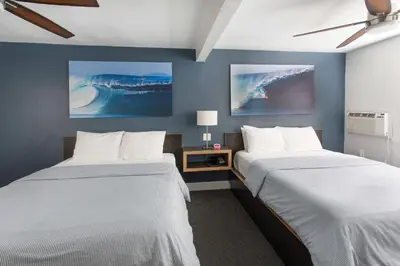 two beds in a room with blue walls at Beach Haven in San Diego