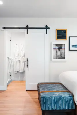 a bedroom with a bed and a sliding door at Del Mar Beach Hotel in San Diego