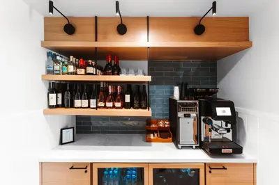 a kitchen with bottles of wine on shelves at Del Mar Beach Hotel in San Diego