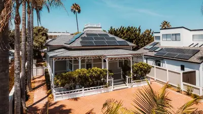 an aerial view of a house with solar panels on the roof at Del Mar Beach Hotel in San Diego