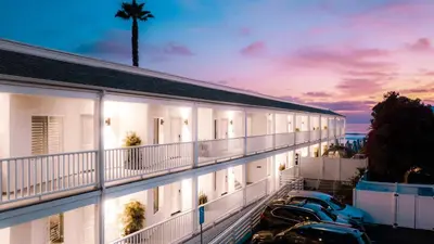 a view of a building with cars parked in front at Del Mar Beach Hotel in San Diego