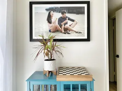 a picture of a man and a woman sitting on a table at OCLuxeBnB Private Resort Living Minutes from Beach in Laguna Hills
