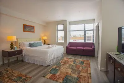 a bedroom with a bed and a purple couch at Comfy Studio with Cali King Size Mattress in San Diego