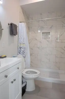 a white bathroom with a toilet and a shower at Comfy Studio with Cali King Size Mattress in San Diego