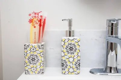 two vases sitting on a counter next to a sink at Comfy Studio with Cali King Size Mattress in San Diego