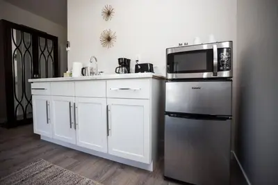 a kitchen with a stainless steel refrigerator and a microwave at Cozy Studio next to San Diego DT and Balboa Park in San Diego