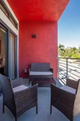 a room with a red wall with chairs and tables at Cozy Studio next to San Diego DT and Balboa Park in San Diego
