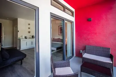 a room with a red wall and a room with a bed at Cozy Studio next to San Diego DT and Balboa Park in San Diego