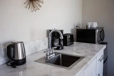 a kitchen counter with a sink and a microwave at Cozy Studio next to San Diego DT and Balboa Park in San Diego