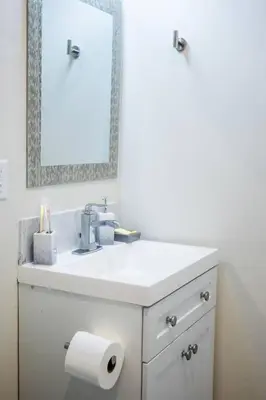 a white bathroom with a sink and a mirror at 1-Bedroom with Cali King Size Bed in San Diego in San Diego