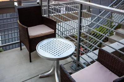 a chair and a table on a balcony at 1-Bedroom with Cali King Size Bed in San Diego in San Diego